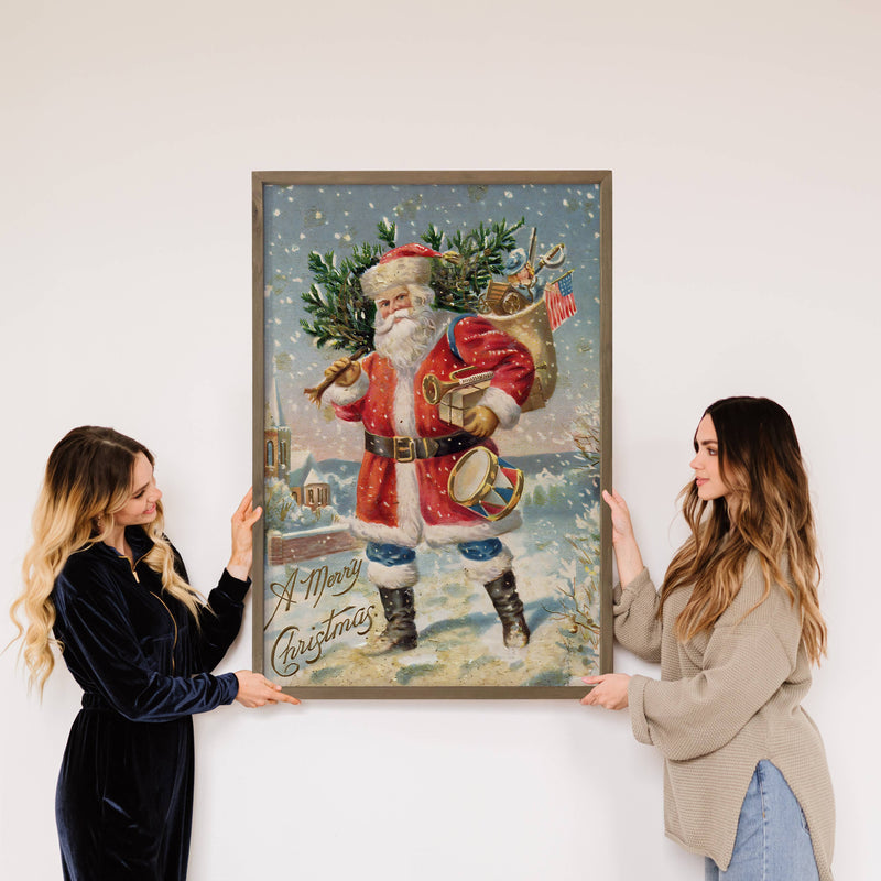 Santa Carrying Tree - Framed Holiday Canvas Art - Wall Art